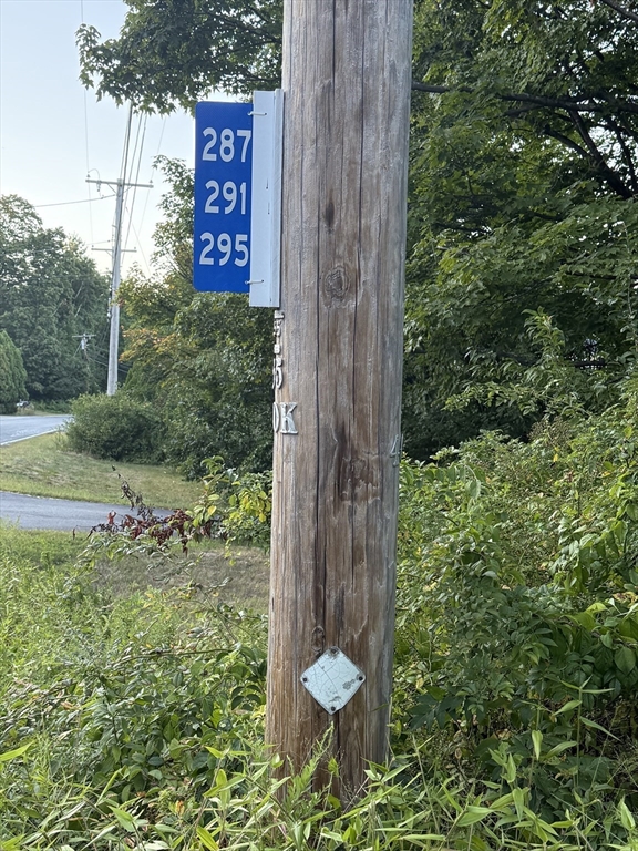 291 Harvard Road Bolton, MA 01740 - Photo 37 of 40 a view of a sign board with tall trees