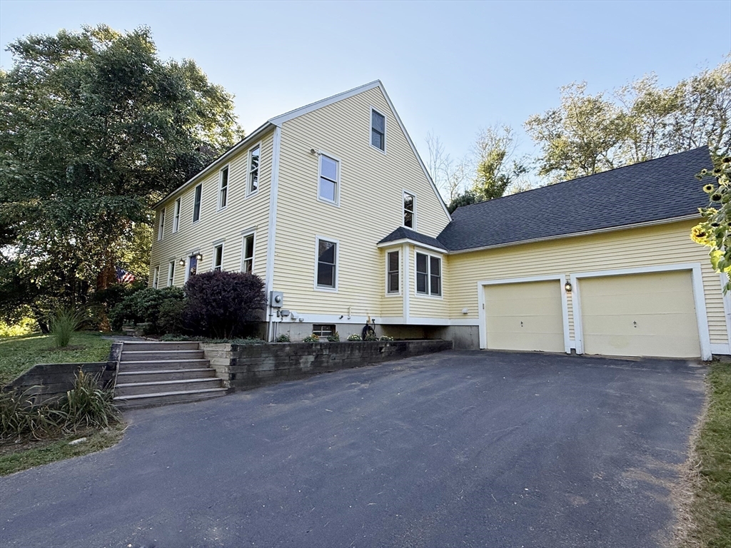 291 Harvard Road Bolton, MA 01740 - Photo 4 of 40 a view of a house with backyard and sitting area