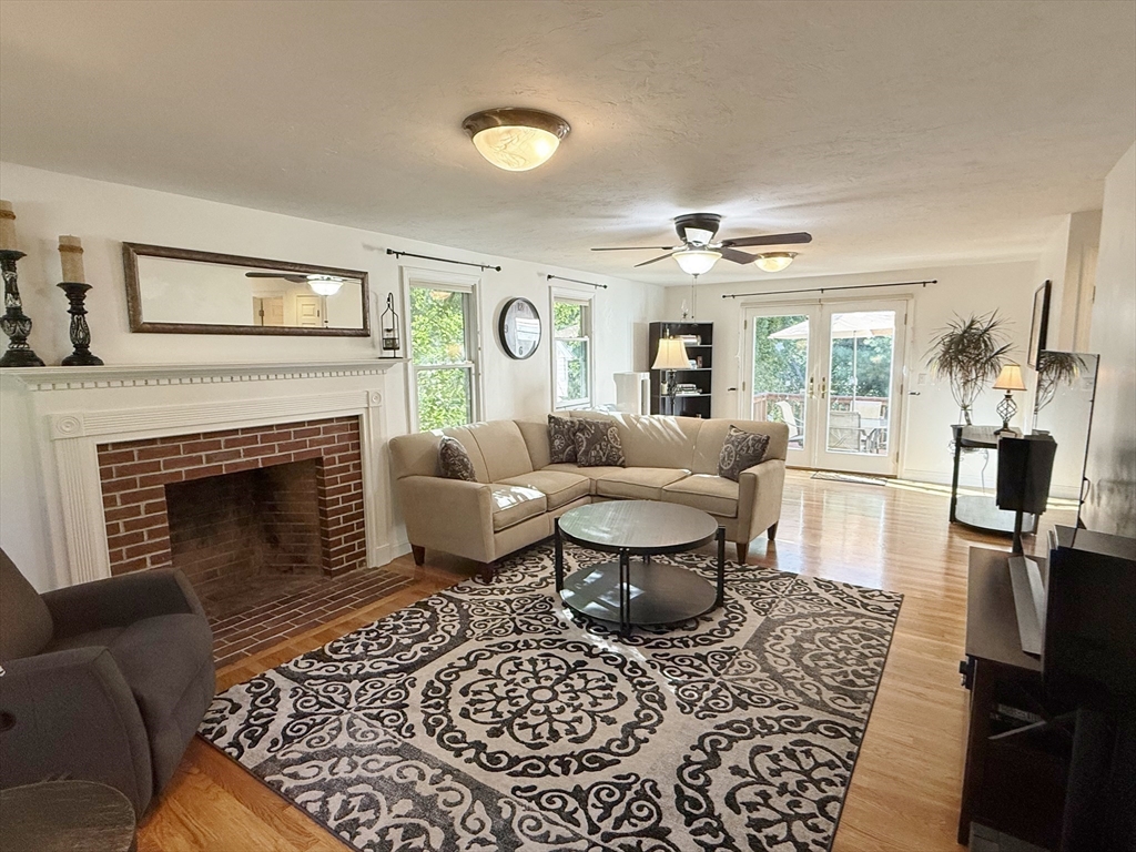291 Harvard Road Bolton, MA 01740 - Photo 8 of 40 a living room with furniture and a fireplace