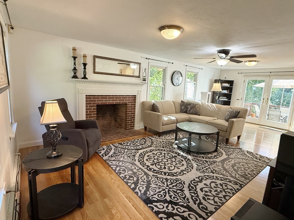 291 Harvard Road Bolton, MA 01740 - Photo 9 of 40 a living room with furniture and a fireplace