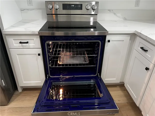 a stove top oven sitting inside of a kitchen