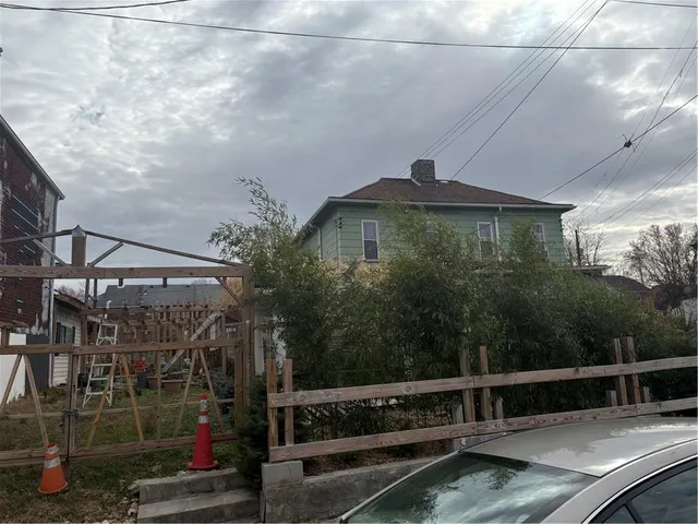 a roof deck with table and chairs and potted plants