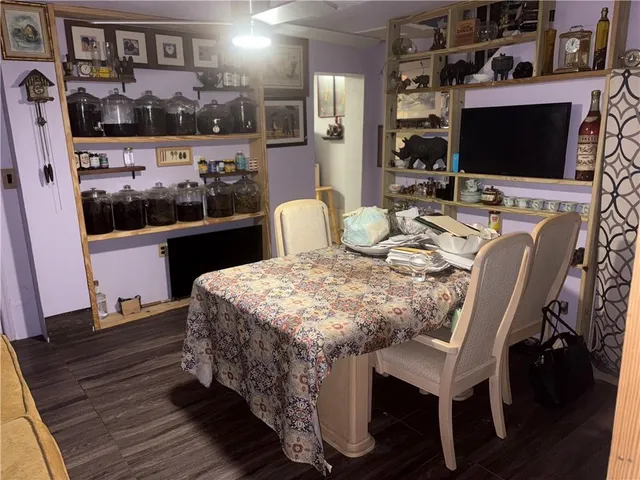 a dining room with furniture and wooden floor