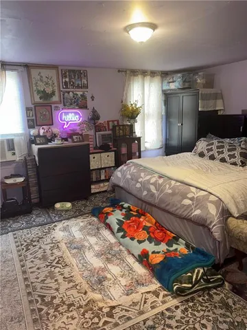 a bedroom with a bed and a dresser