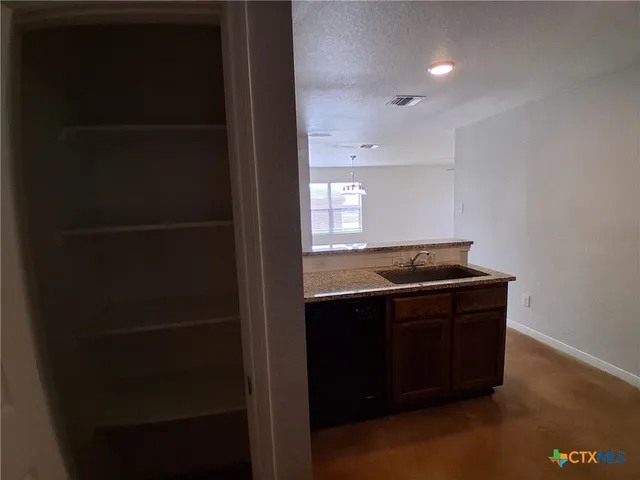 a room with a sink and a mirror