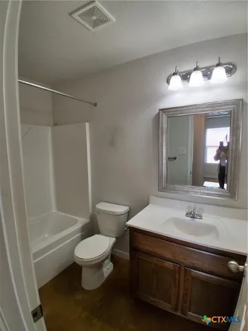 a bathroom with a sink toilet and a mirror