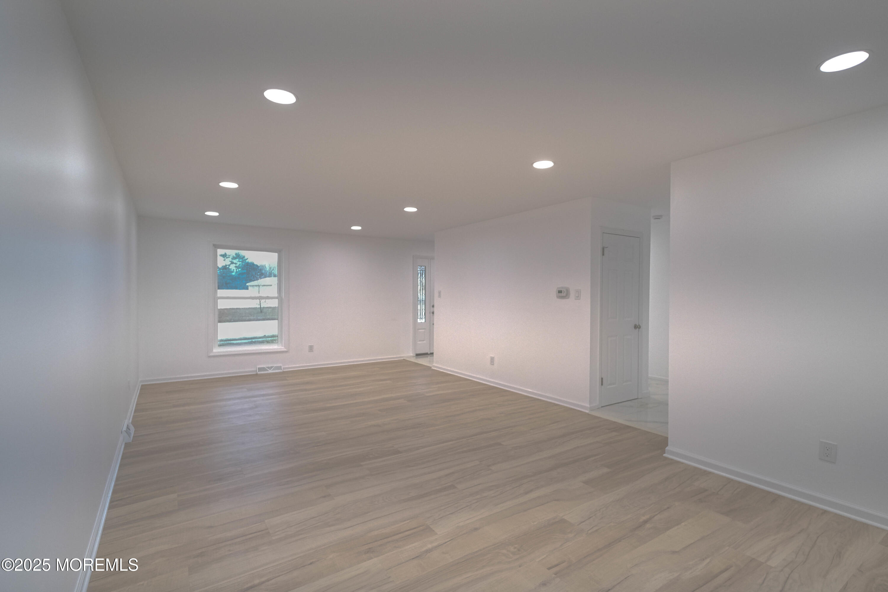 125 Shore Road Marmora, NJ 08223 - Photo 14 of 26 an empty room with wooden floor and windows