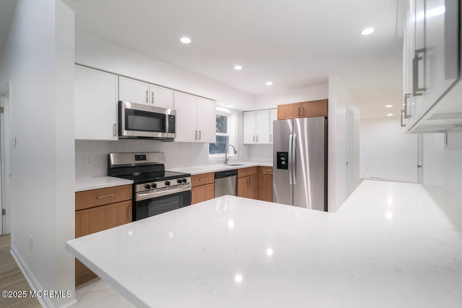 125 Shore Road Marmora, NJ 08223 - Photo 6 of 26 a large white kitchen with a refrigerator a stove top oven a sink and dishwasher