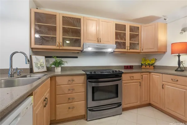 a kitchen with cabinets appliances and a sink