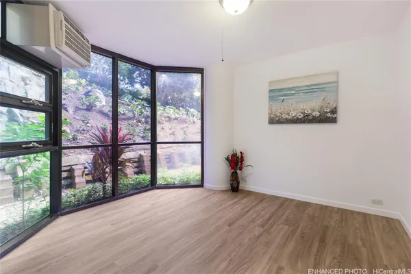 wooden floor in an empty room with a window