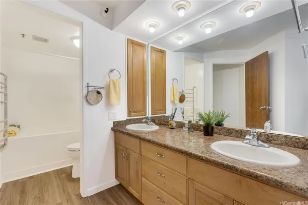 a bathroom with a granite countertop sink mirror and double
