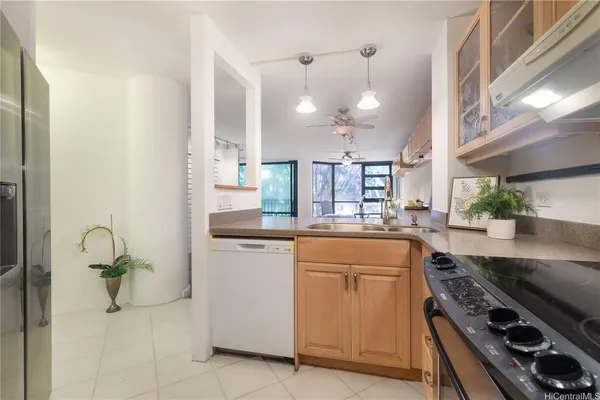 a kitchen with a sink appliances and cabinets