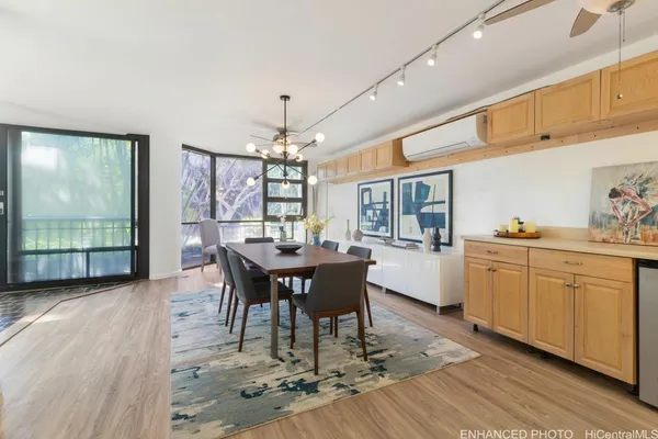 a view of a dining room with furniture a chandelier and wooden floor