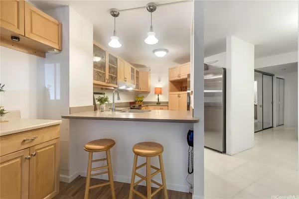 a kitchen with stainless steel appliances granite countertop a sink and a refrigerator