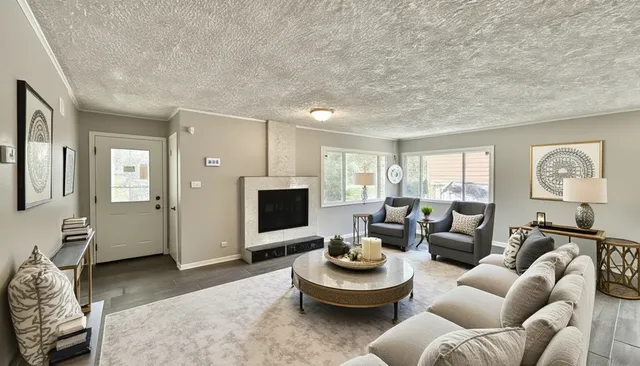 a living room with furniture and a fireplace
