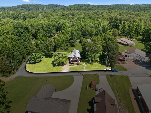 an aerial view of a house with a yard
