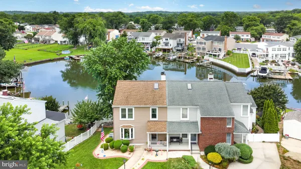 an aerial view of multiple houses with yard