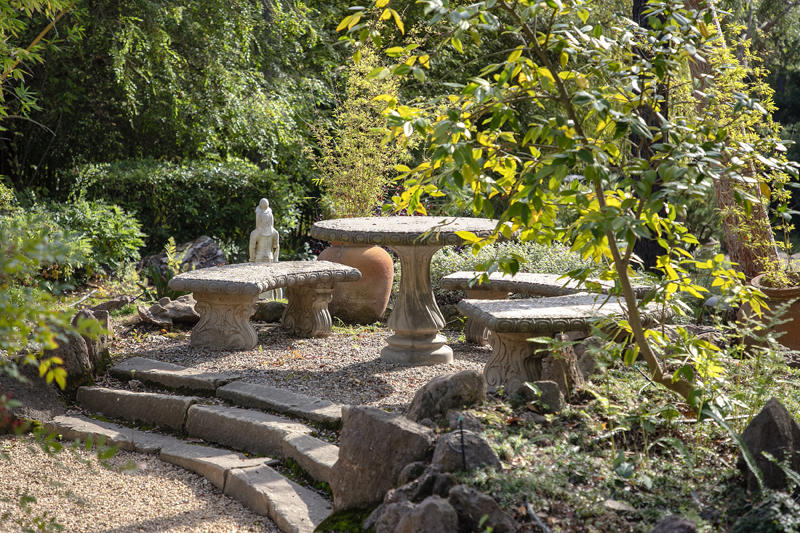 800 Cold Spring Road Santa Barbara, CA 93108 - Photo 23 of 23 a view of a backyard with table and chairs potted plants and large tree
