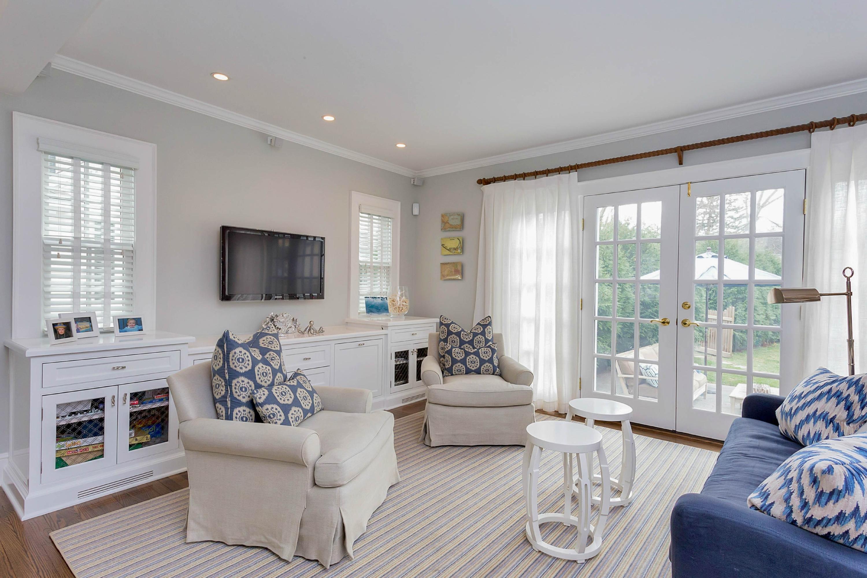 6 Sunset Road Darien, CT 06820 - Photo 13 of 24 a living room with furniture a flat screen tv and a floor to ceiling window
