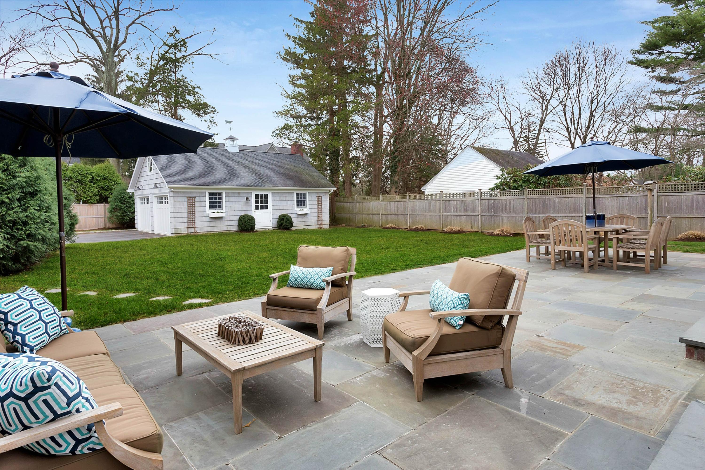 6 Sunset Road Darien, CT 06820 - Photo 22 of 24 a view of a patio with couches table and chairs under an umbrella