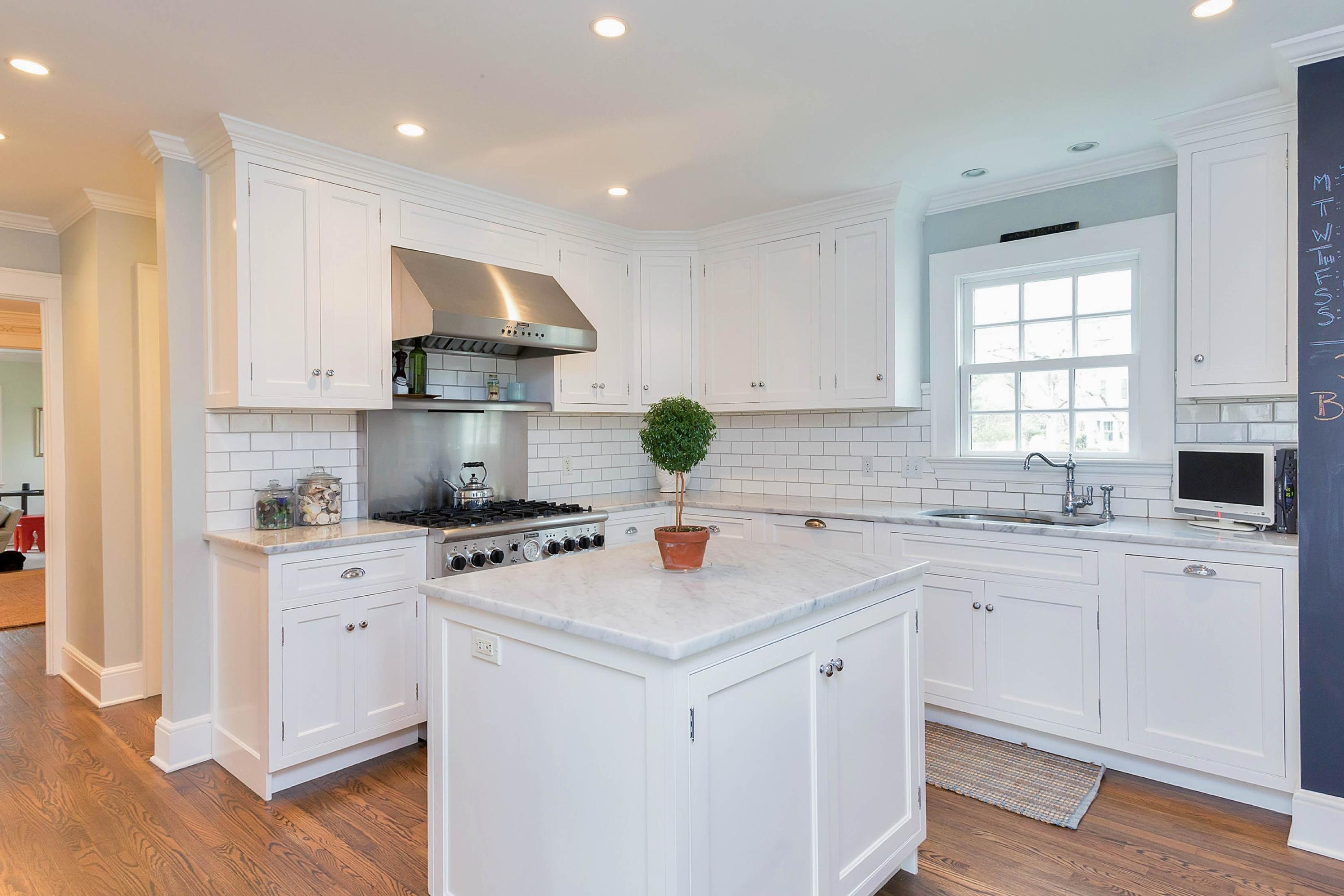 6 Sunset Road Darien, CT 06820 - Photo 9 of 24 a kitchen with white cabinets and white appliances