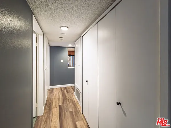 a view of hallway with wooden floor
