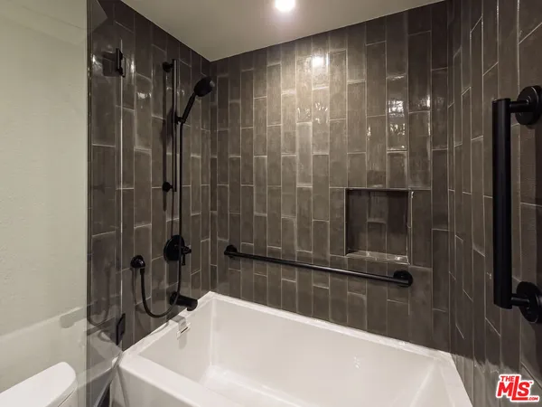 a bathroom with a bathtub and a shower