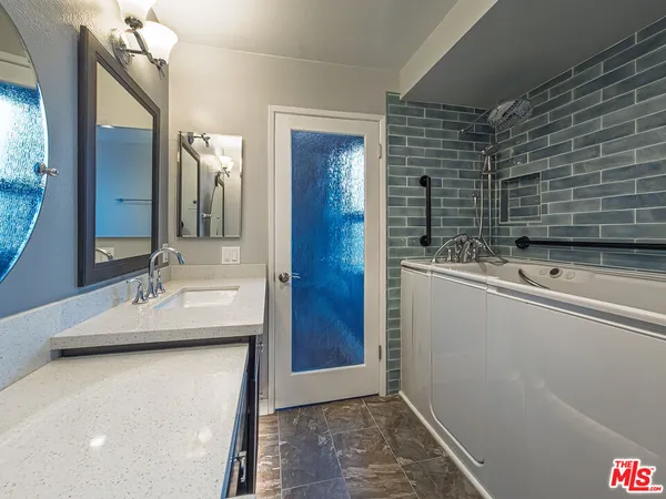 a bathroom with a sink and a mirror