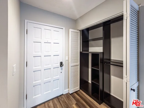 a view of walk in closet with empty racks