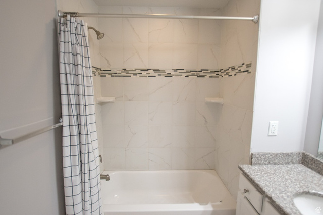 2150 South Main Street, Unit R405 Salt Lake City, UT 84115 - Photo 18 of 20 Tiled shower and bathtub combination featuring a decorative mosaic accent band