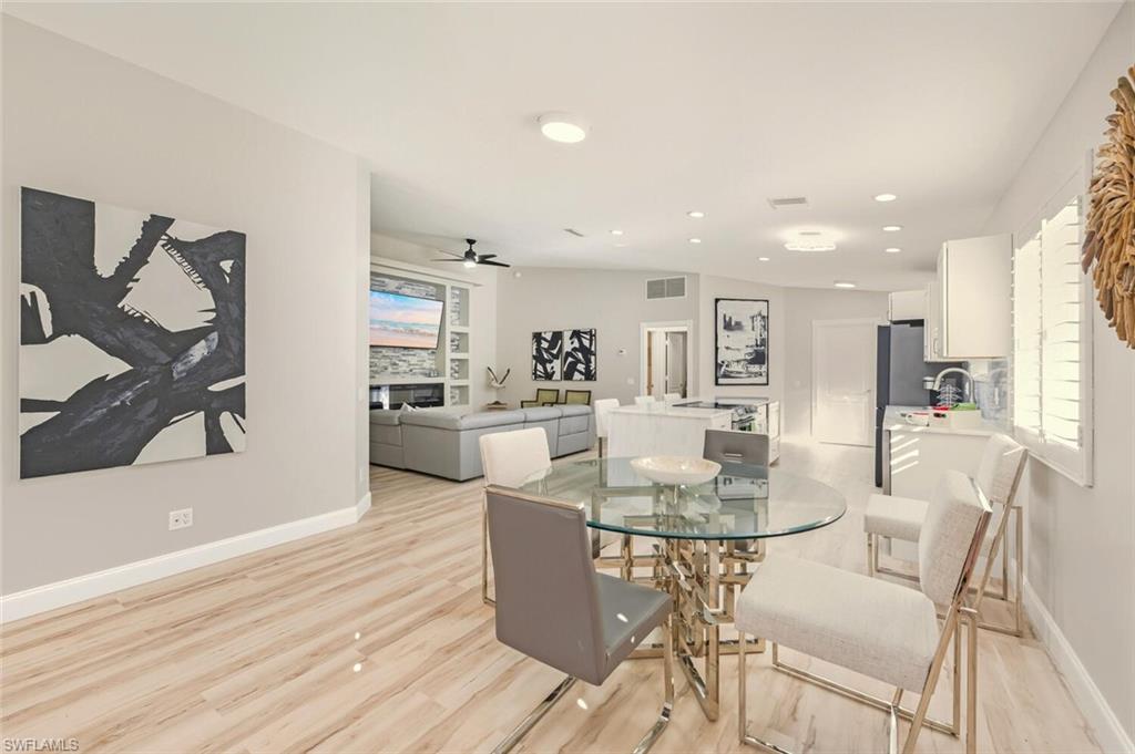 3408 Cayman Lane Naples, FL 34119 - Photo 11 of 34 a view of a dining room with furniture and wooden floor