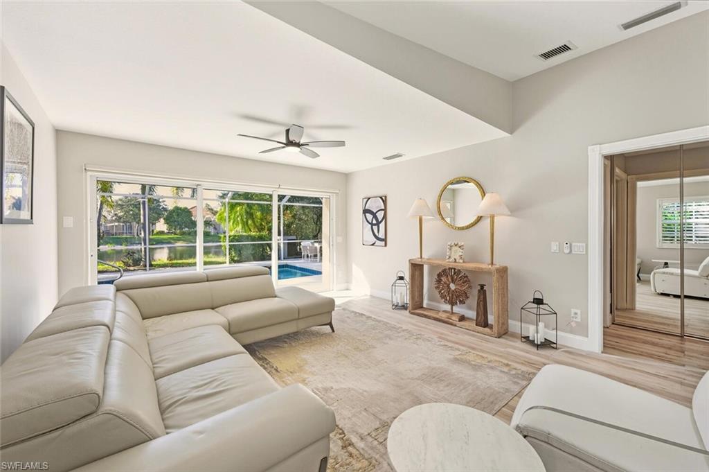 3408 Cayman Lane Naples, FL 34119 - Photo 12 of 34 a living room with furniture and a large window