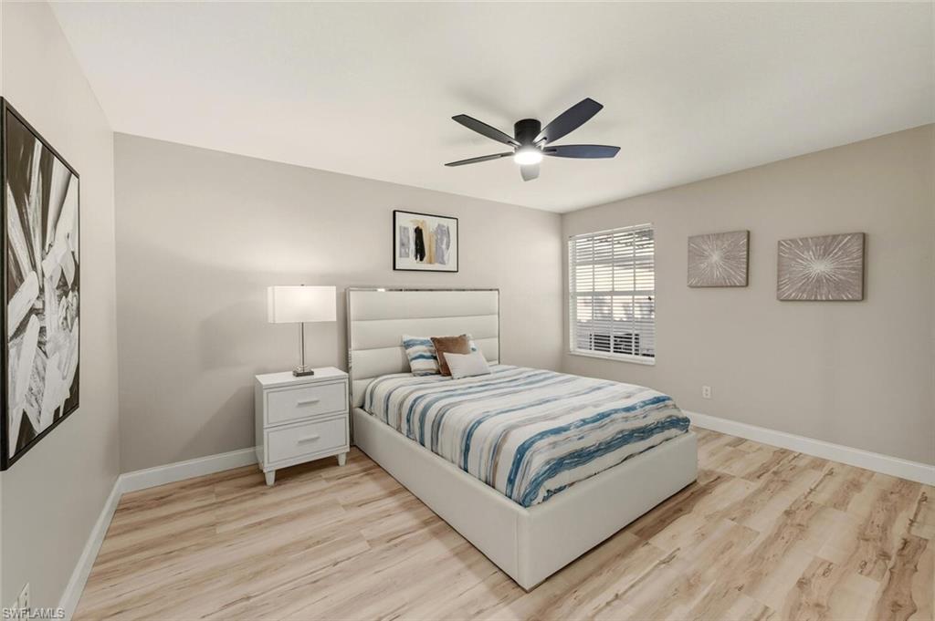 3408 Cayman Lane Naples, FL 34119 - Photo 17 of 34 a bedroom with a bed and a window