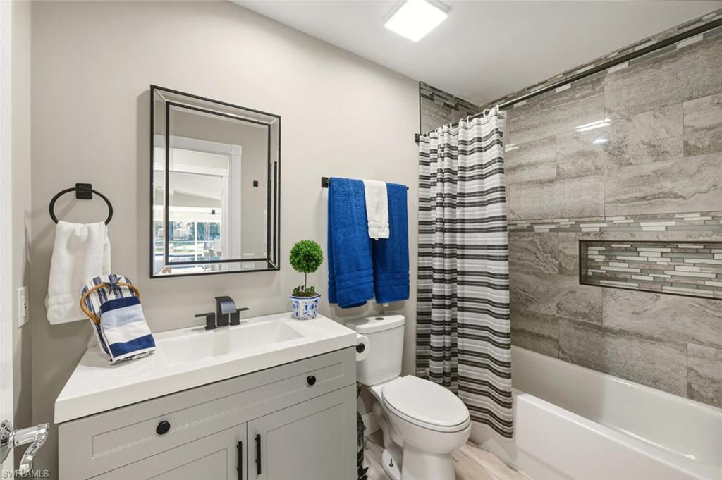 3408 Cayman Lane Naples, FL 34119 - Photo 19 of 34 a bathroom with a sink a toilet and shower