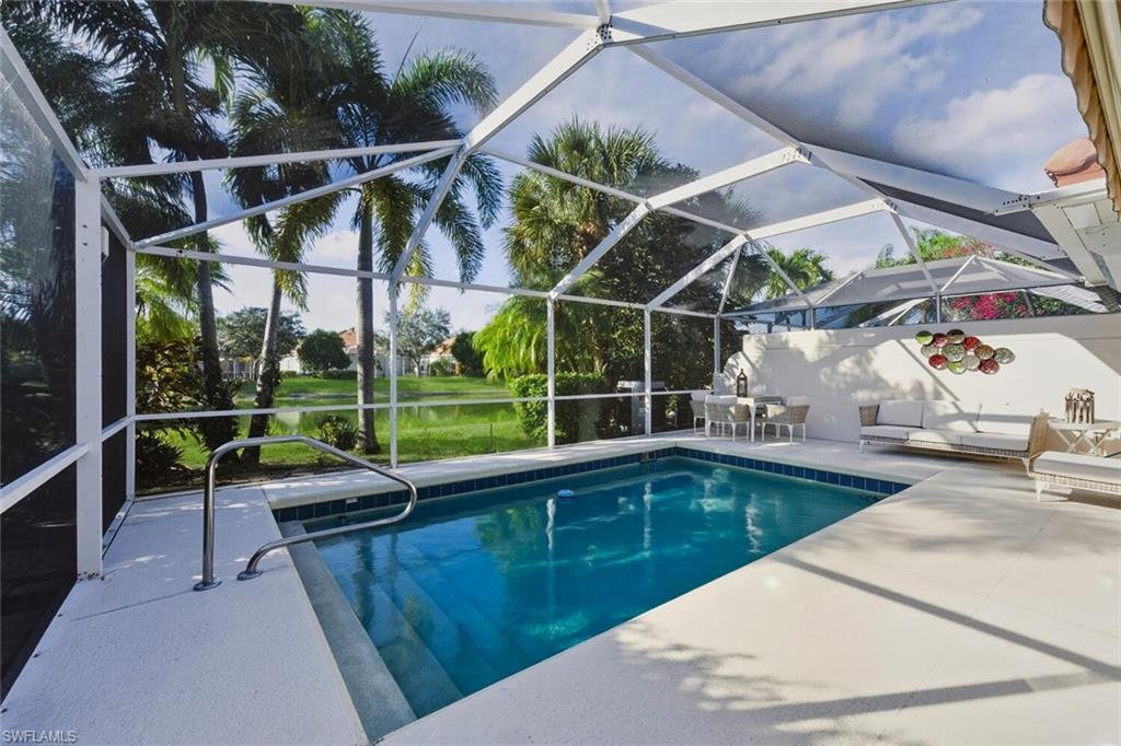 3408 Cayman Lane Naples, FL 34119 - Photo 22 of 34 a view of a swimming pool with a patio