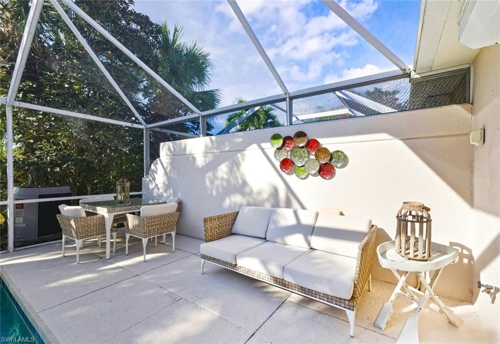 3408 Cayman Lane Naples, FL 34119 - Photo 23 of 34 a roof deck with table and chairs