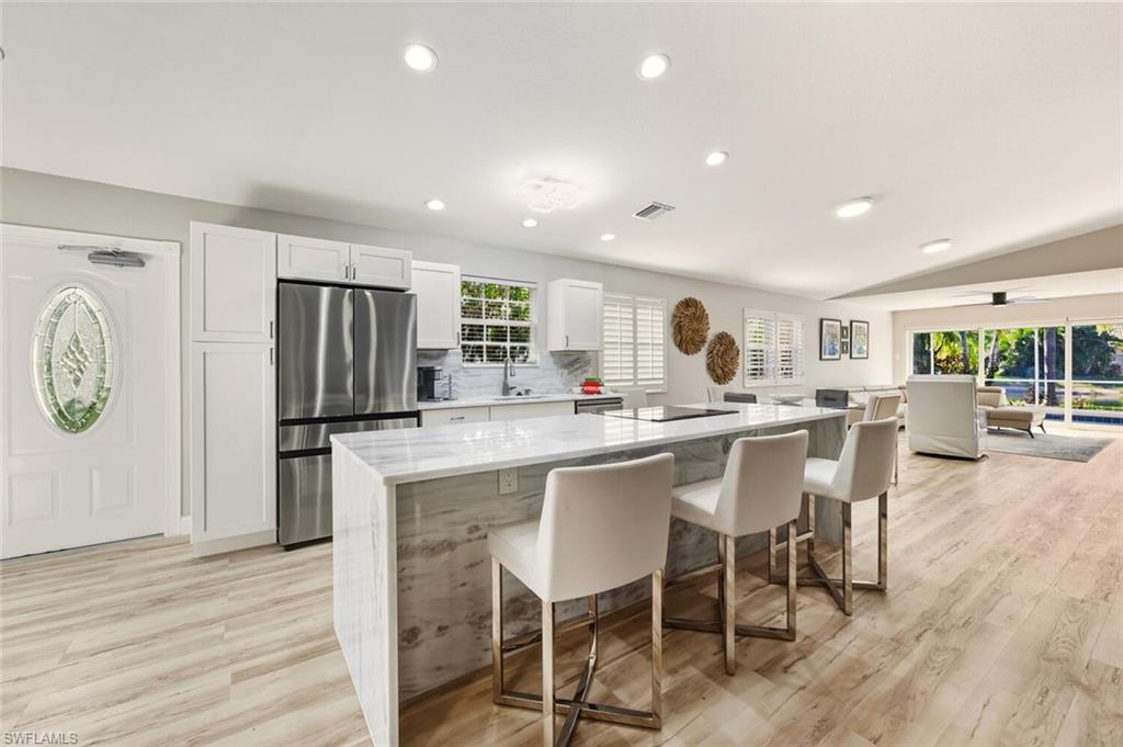 3408 Cayman Lane Naples, FL 34119 - Photo 3 of 34 a large kitchen with a table and chairs