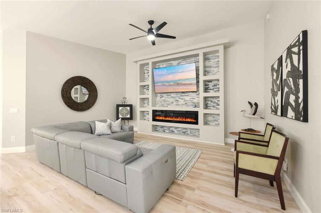 3408 Cayman Lane Naples, FL 34119 - Photo 6 of 34 a living room with furniture a large window and a table