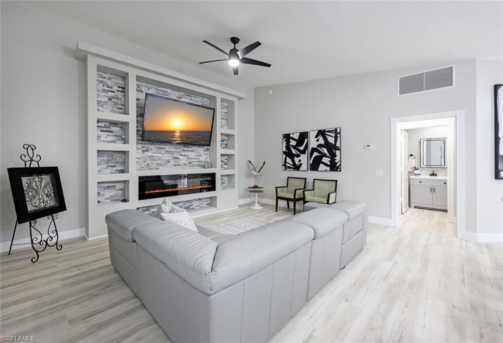 3408 Cayman Lane Naples, FL 34119 - Photo 8 of 34 a living room with furniture and a fireplace