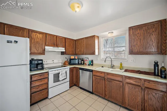 a kitchen with a white cabinets and white appliances