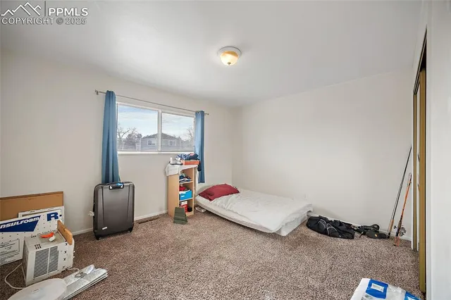 a bedroom with furniture and a window
