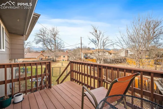 a view of roof deck with wooden floor and fence