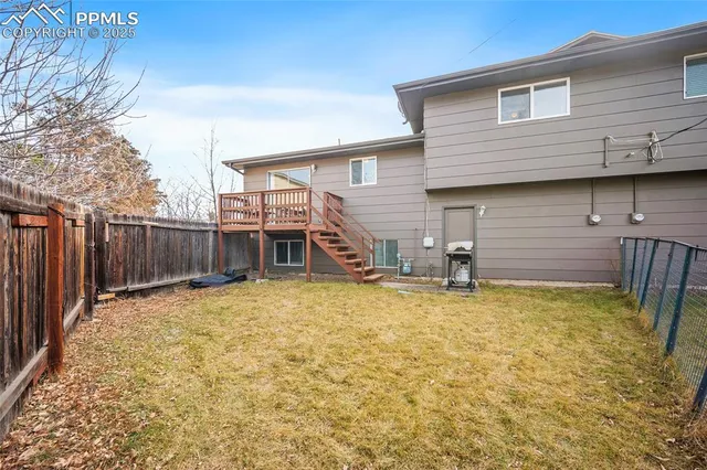 a view of a house with wooden fence