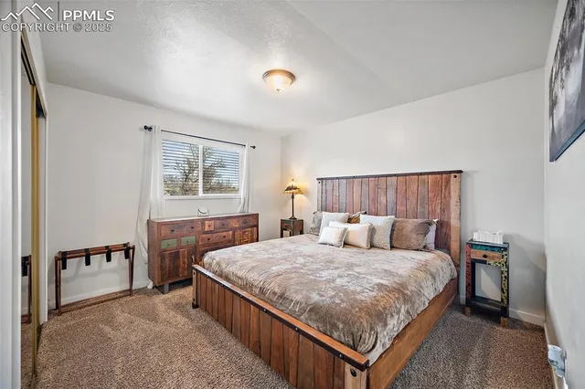 a bedroom with a bed and a night stand