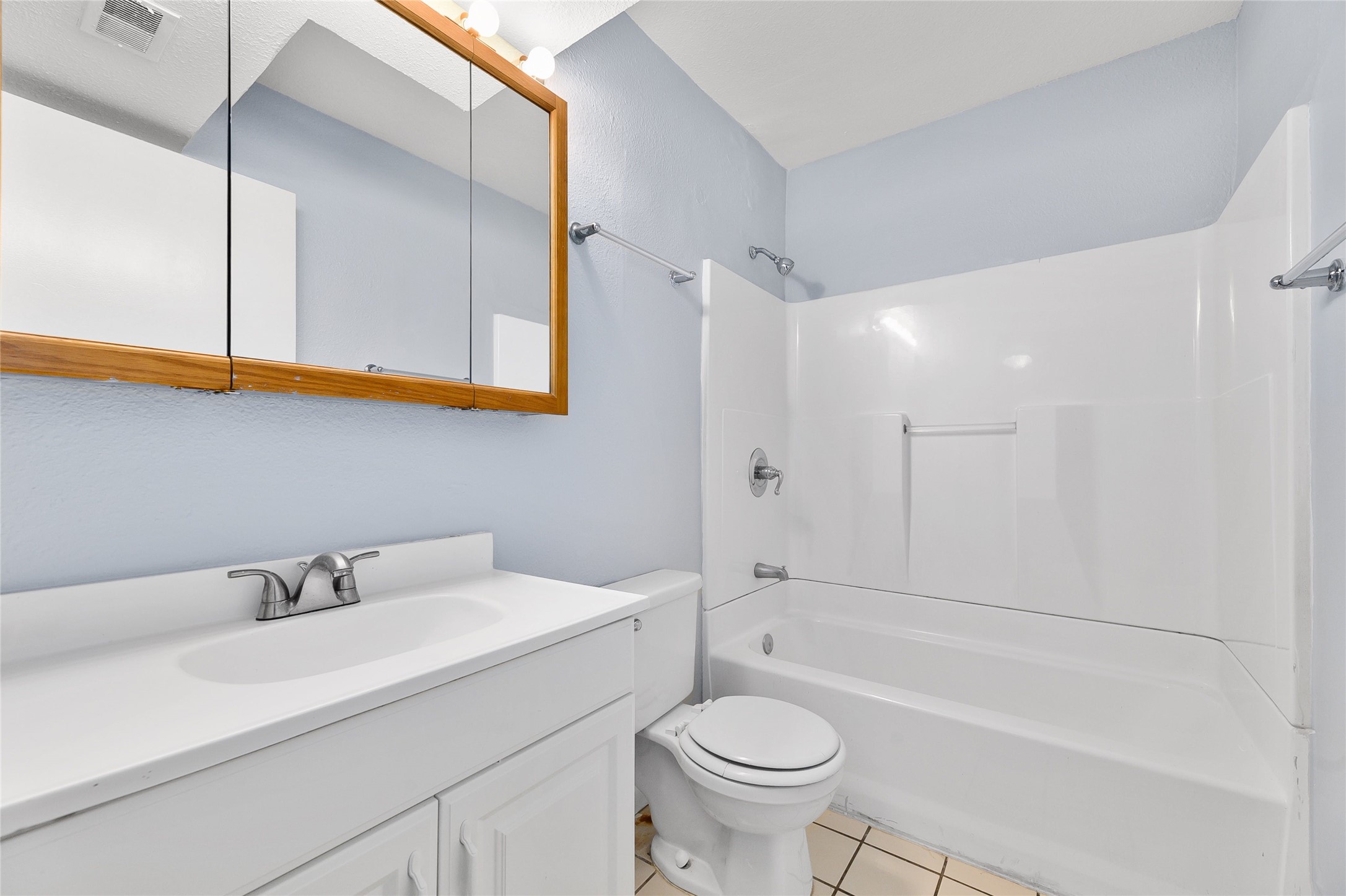 2408 Longview Street, Unit 113 Austin, TX 78705 - Photo 19 of 23 Full bath with bathing tub / shower combination, light tile patterned floors, and vanity