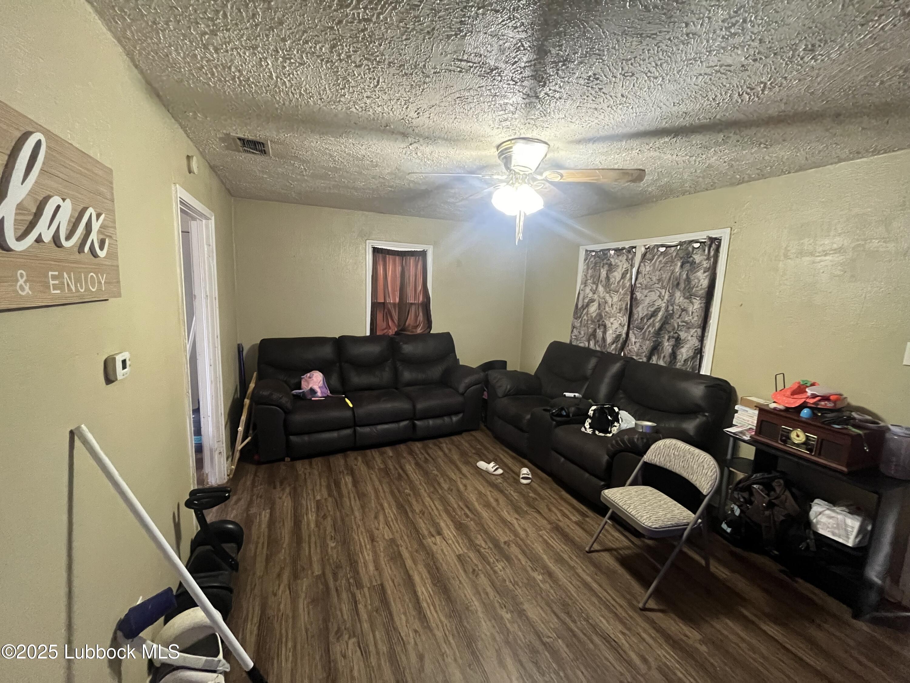 2709 41st Street Lubbock, TX 79413 - Photo 2 of 7 a living room with furniture and wooden floor