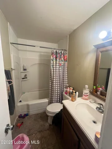 a bathroom with a sink toilet vanity tub and shower