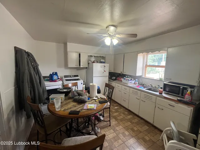a kitchen with a dining table and chairs