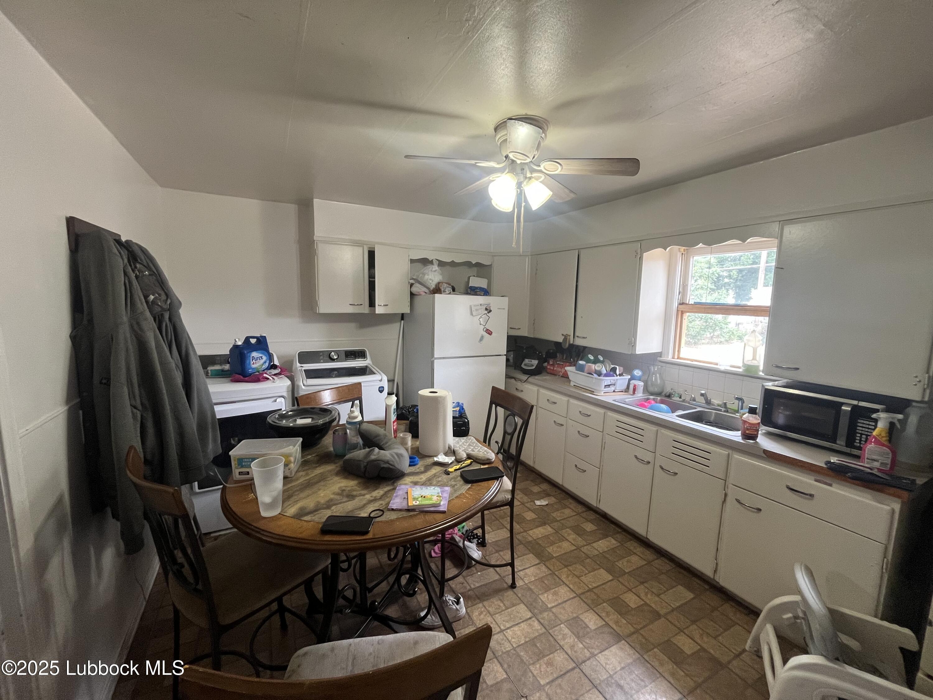 2709 41st Street Lubbock, TX 79413 - Photo 6 of 7 a kitchen with a dining table and chairs