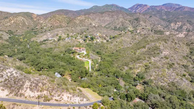 a view of a large mountain with mountains in the background